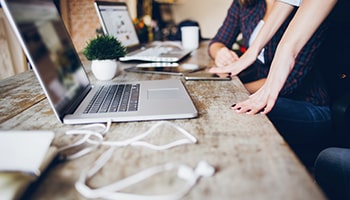 Laptop, tablet and mobile devices on wooden desk